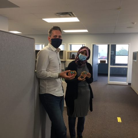 man and woman in masks with cookies in their hands