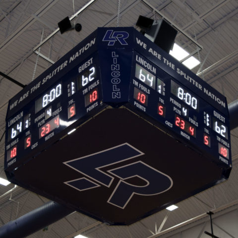 View looking up at a 4 sided basketball scoreboard showing off the high school logo LR