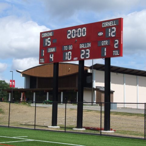 red scoreboard at outdoor playing field