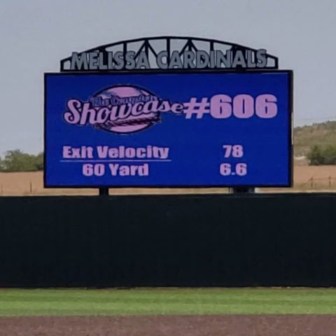 View of a baseball field with the view of the scoreboard in the background.