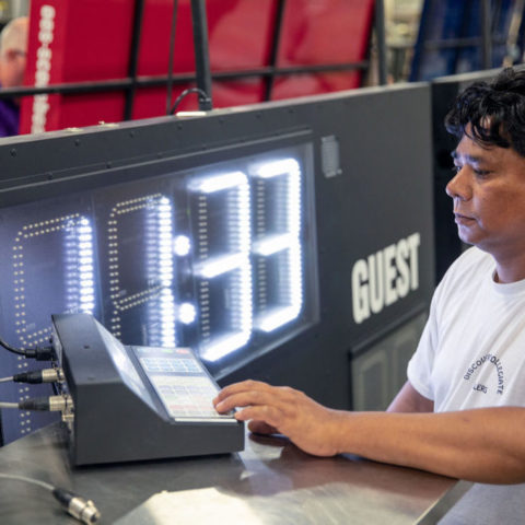 man setting up scoreboard controls