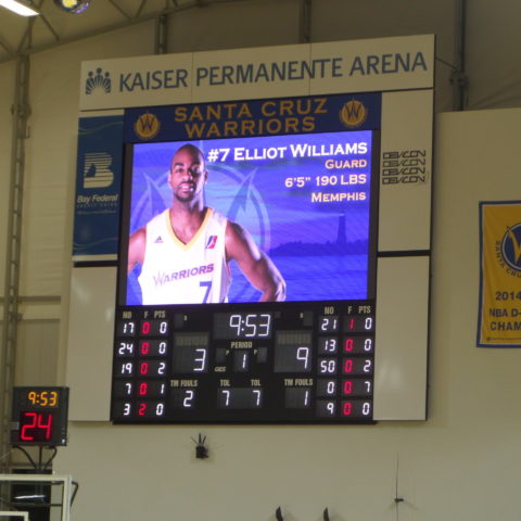 Basketball scoreboard with picture of player on the screen.