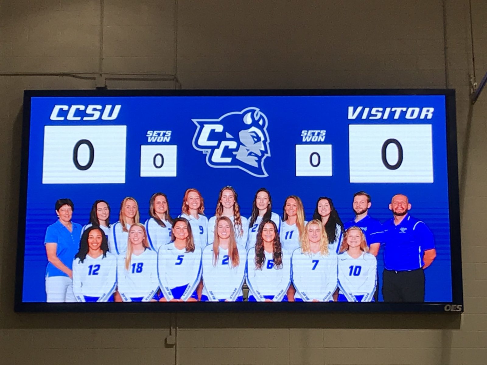 The Central Connecticut indoor scoreboard with an image of the volleyball team.