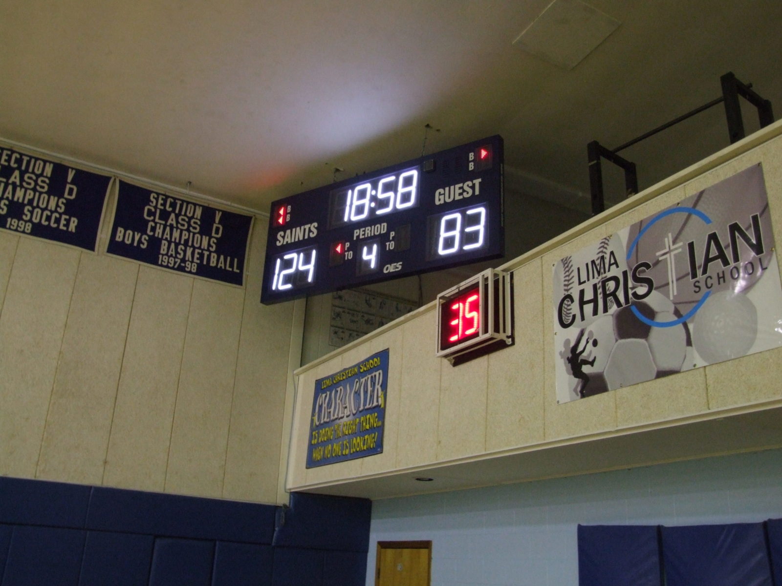 An indoor basketball scoreboard with a shot clock below.