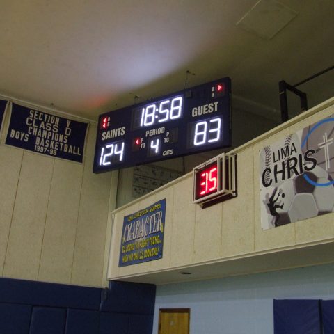 An indoor basketball scoreboard with a shot clock below.