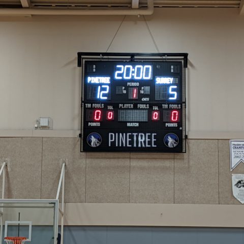 small basketball scoreboard in a gym