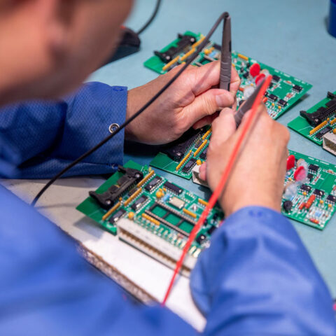 Close up of hands fixing circuit