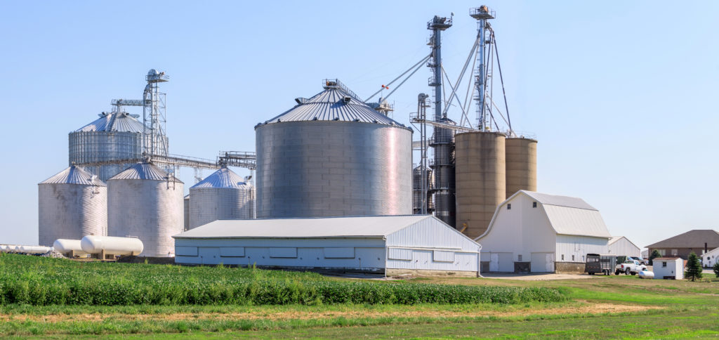 A modern grain elevator facility in a small rural town.