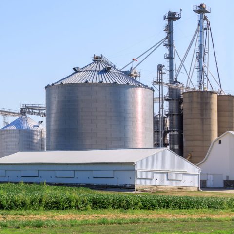 A modern grain elevator facility in a small rural town.